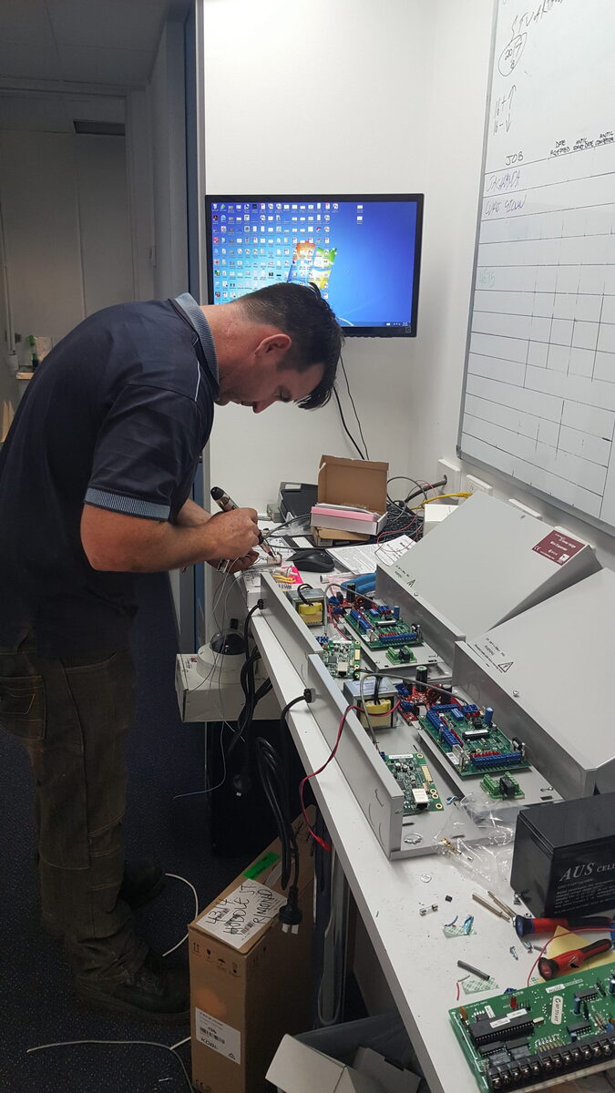 Access Alarms technician servicing a security system for a Chermside customer